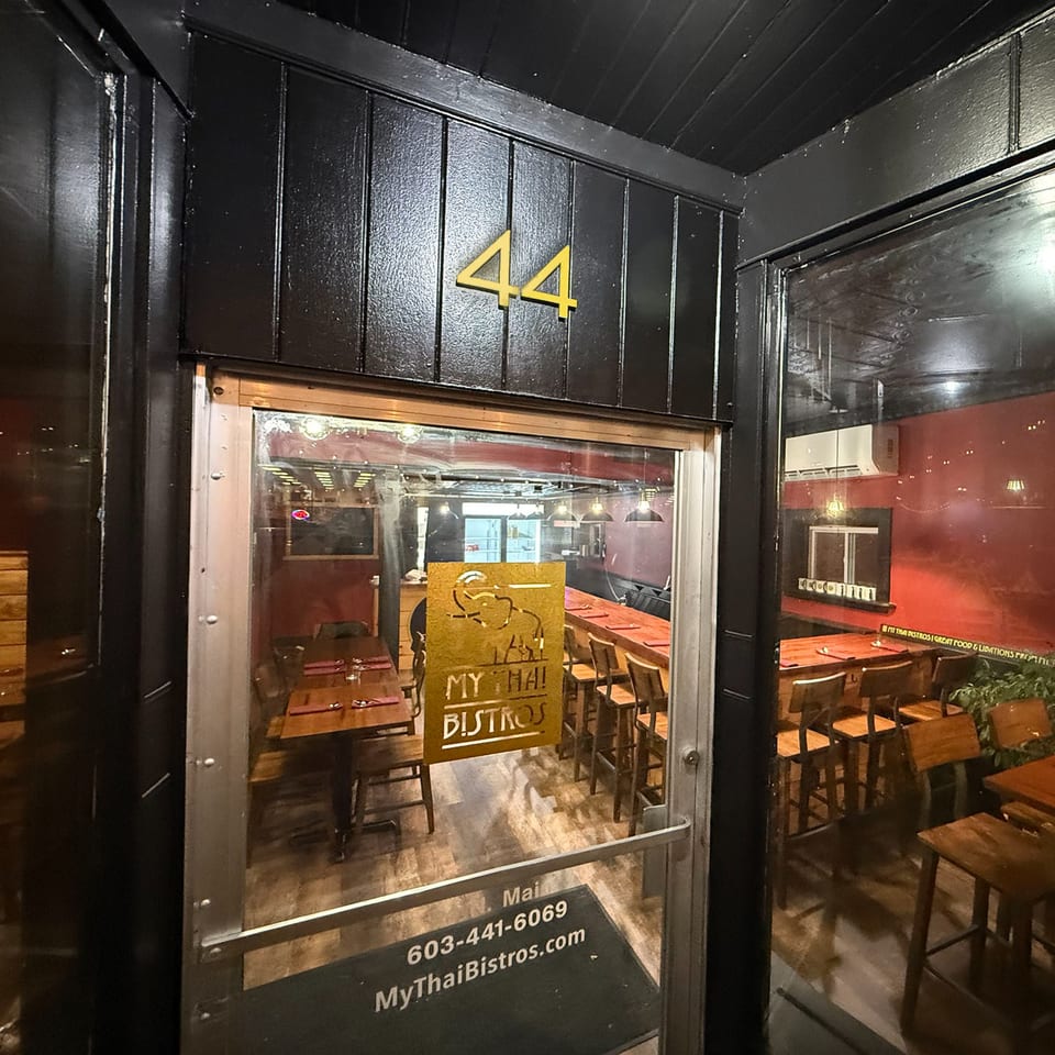 Exterior view of My Thai Bistros entrance with "44" above the door and interior visible.