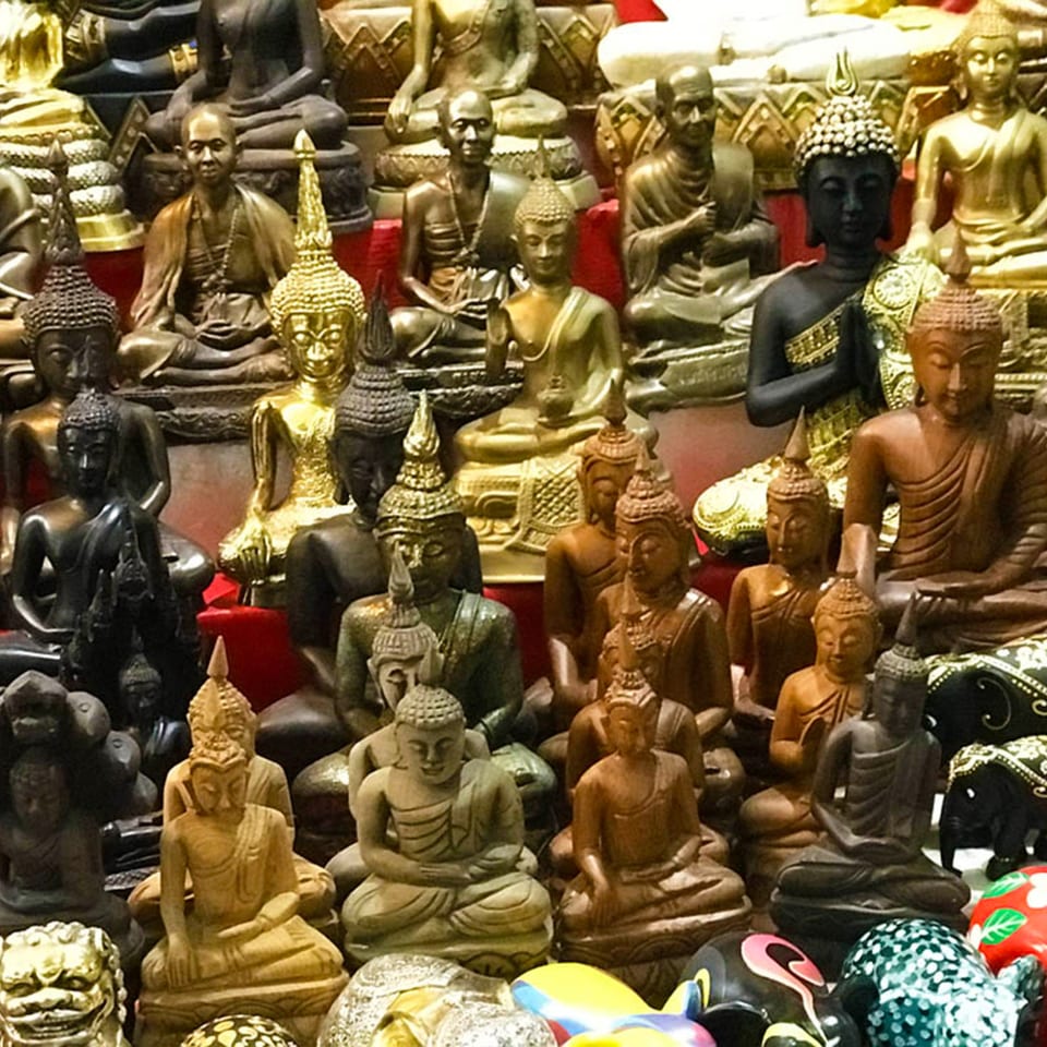A collection of various Buddha statues in different sizes, materials, and poses.